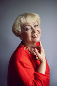 Portrait of young woman against blue background