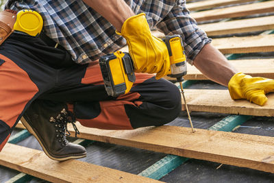 Low section of man working at workshop