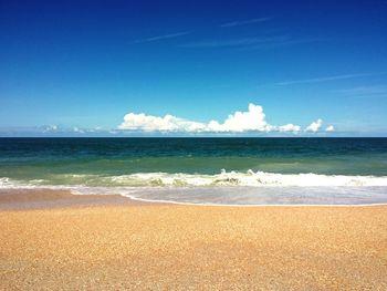 View of beach against blue sky