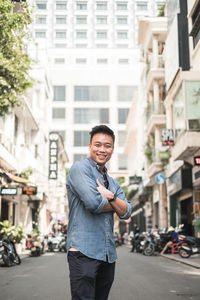 Portrait of young man standing on road