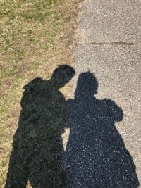 High angle view of friends shadow on floor