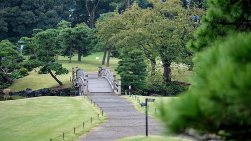 A wooden bridge at hamarikyu gardens in midst tokyo city, japan.