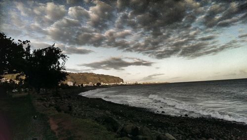 Scenic view of beach against sky during sunset