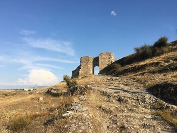 Low angle view of old ruin against sky