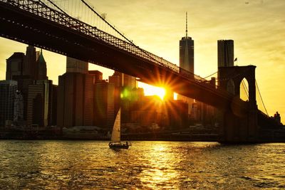 Brooklyn bridge over east river at sunset