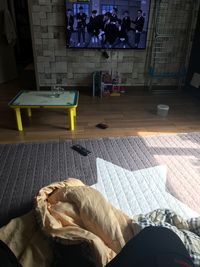 View of messy bed in bedroom