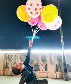 Portrait of woman holding balloons