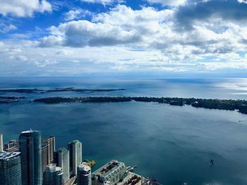 High angle view of buildings by sea against sky