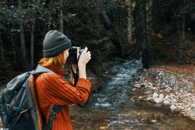 Woman photographing in water