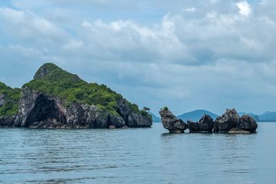 Scenic view of rock formation in sea against sky