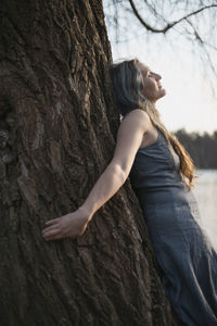 Close up woman spiritually connecting with willow tree portrait picture