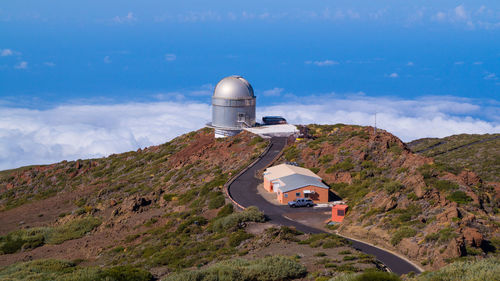 Built structure on mountain against sky