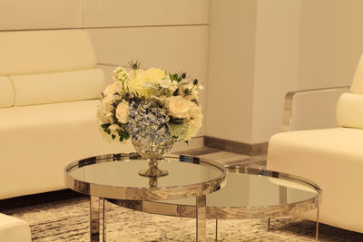 Close-up of flower vase on table at home