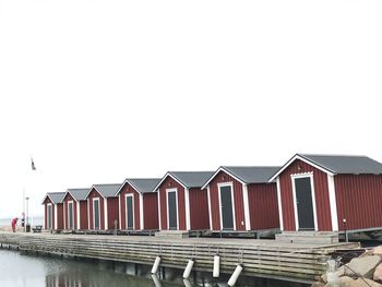 Row of houses on beach against clear sky