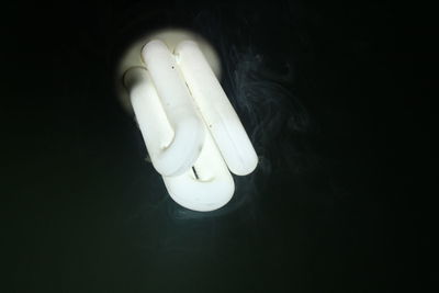 Close-up of light bulb against black background
