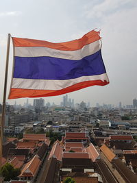 High angle view of flag against buildings in city