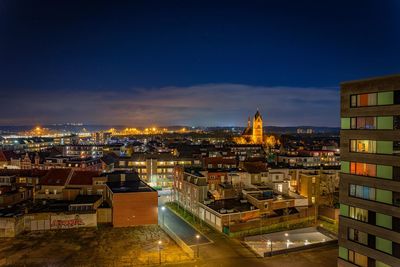 High angle view of illuminated buildings in city at night