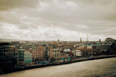 Cityscape against cloudy sky