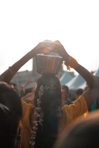 People at music concert against sky