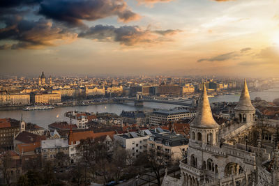 High angle view of illuminated buildings against sky during sunset