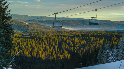 Scenic view of ski lift against sky