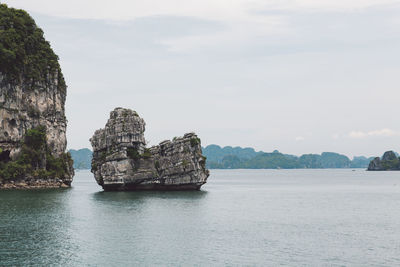 Scenic view of rock formation in sea against sky