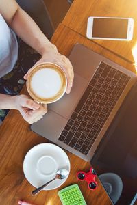 Midsection of coffee cup on table