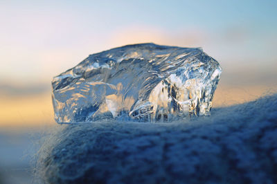 Close-up of frozen sea against sky during winter