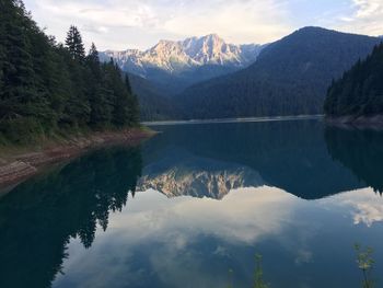 Scenic view of lake and mountains against sky