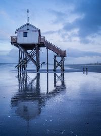 Lifeguard hut on beach against sky