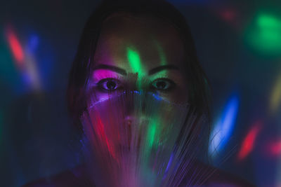 Close-up portrait of young man with illuminated fiber optics