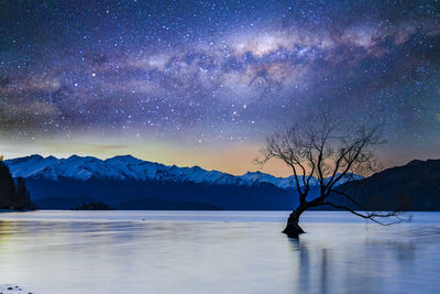 Scenic view of frozen lake against sky at night