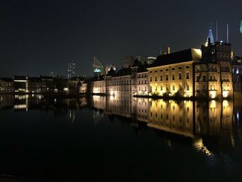 Reflection of buildings in river at night