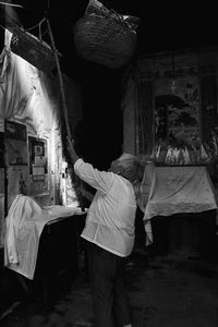 Rear view of people working at market stall