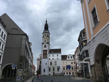 Street amidst buildings against sky in city