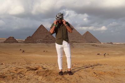 Full length of woman standing on land against sky