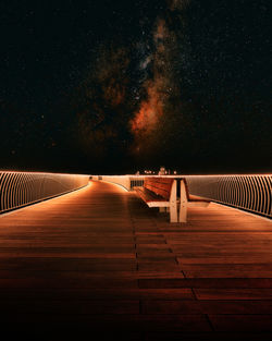 Low angle view of man standing on road at night