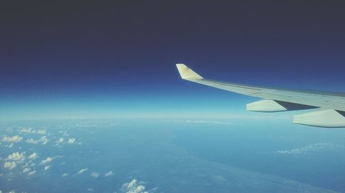 Cropped image of airplane flying over landscape