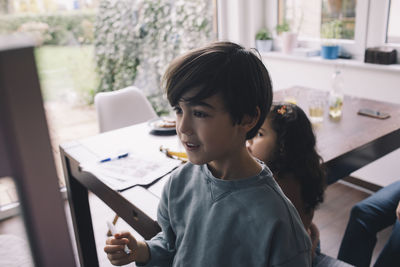 Boy drawing in living room at home