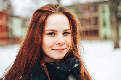 Portrait of smiling young woman in winter