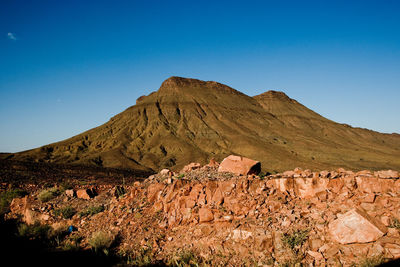 Scenic view of mountains against clear blue sky