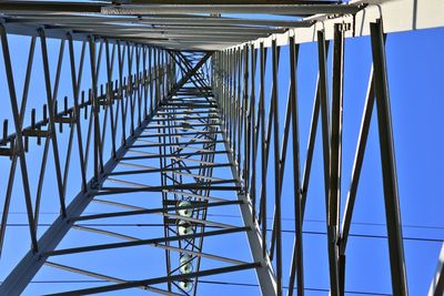 Low angle view of metallic structure against clear blue sky