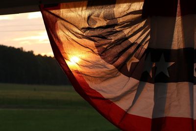 Close-up of flag against sky during sunset