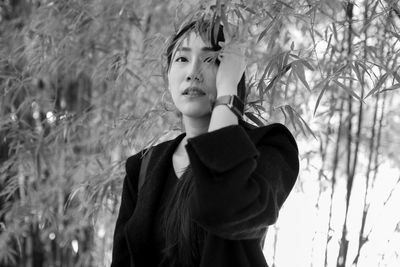 Close-up of woman standing against tree