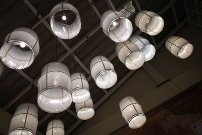 Low angle view of illuminated pendant lights hanging from ceiling