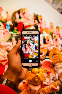 Close-up of hand holding mobile phone