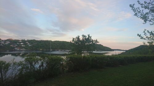 Scenic view of lake against sky at sunset