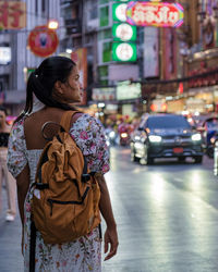 Portrait of young woman standing on street