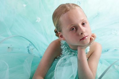 Portrait of cute girl wearing turquoise dress