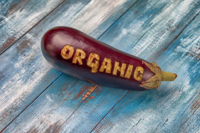 Eggplant with organic text on wooden table